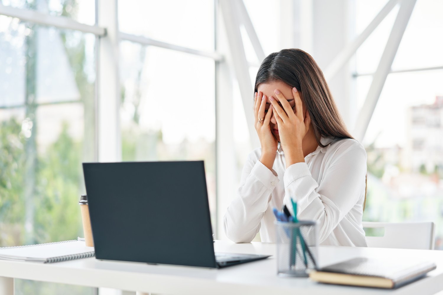 Tired Businesswoman Covering Face with Two Hands 